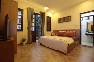 a bedroom with a bed and a television in it at Hanoi Balcony Homestay in Hanoi