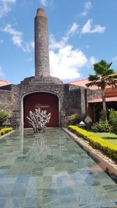 a brick building with a fountain in front of it at Sunile Villa in Flic-en-Flac