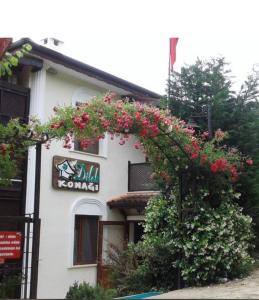 a building with pink flowers on the side of it at Sapanca Dilek Konagi Hotel in Sapanca