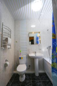 a bathroom with a toilet and a sink at Hotel Kavkaz in Arkhyz