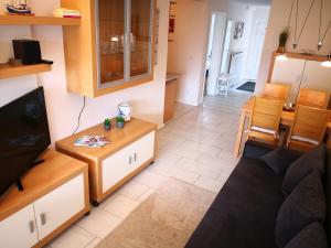 a living room with a couch and a table at Wohnung "Flügge" in Bannesdorf