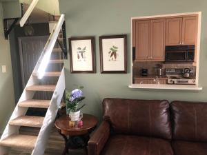 a living room with a couch and a staircase at Spectacular apartment, close to Lions Head, next to bus stop in Vail