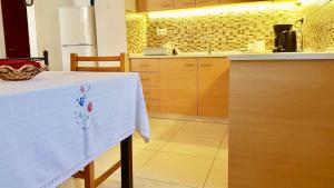 a kitchen with a table with a white table cloth on it at The Metropolis Residence Rhodes in Rhodes Town