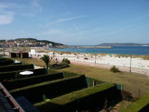 a view of the beach from the balcony of a building at CASA CHALET ATALAYA a pie de playa en Laxe in Laxe