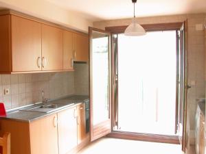 a kitchen with a sink and a sliding glass door at Apartamento Millas in San Juan de Plan