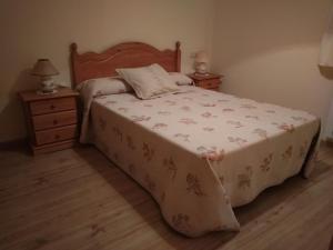 a bedroom with a bed and two night stands at Apartamento Millas in San Juan de Plan