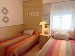 a bedroom with two beds and a window at Alto Palancia Calle Progreso 25 Sot de Ferrer in Sot de Ferrer