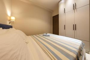 a bedroom with a bed with a towel on it at San Marco Elegant Apartment Zante in Zakynthos