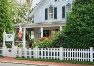 a white picket fence in front of a house at Hob Knob in Edgartown