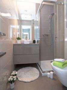 a bathroom with a shower and a toilet and a sink at WLR Apartments - Hoza II in Warsaw