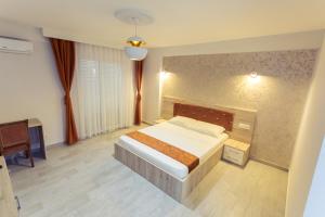 a large bedroom with a bed and a desk at CITY HOTEL in Ferizaj