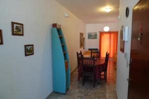 a room with a blue staircase and a dining room at Departamento Centrico in Villa Carlos Paz