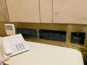 a phone sitting on a table in a room at THE SINGH EMPIRE, New Delhi in New Delhi