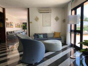 a living room filled with furniture and a large window at Arthotel Gabbiano Azzurro Due in Marciana Marina