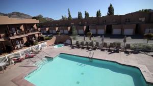 a pool at a hotel with chairs and a resort at Casa Del Mila Oro Condo in Osoyoos