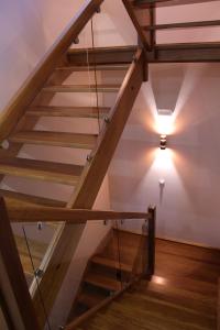 a wooden staircase with a light on the ceiling at Hotel Rural Oasibeth in Frómista