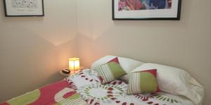 a bedroom with a bed with pillows and a lamp at boel boutique 2 in Guayaquil