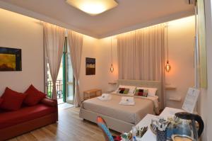 een slaapkamer met een bed en een rode bank bij B&B CasaZeni in Napels