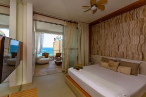 a bedroom with a bed and a view of the ocean at Dco Suites Lounge & Spa in Máncora