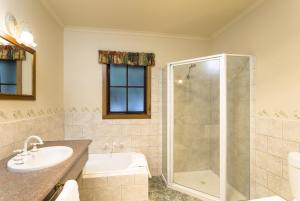 a bathroom with a sink and a shower at Cradle forest inn in Moina