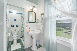 a bathroom with a sink and a toilet and a mirror at Old Hawaiian Bed and Breakfast in Hilo +37 photos