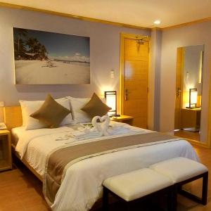 
a hotel room with a large bed and a large mirror at Shore Time Hotel Boracay in Boracay

