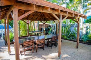 a wooden gazebo with a table and chairs at Tripcony Quays in Caloundra