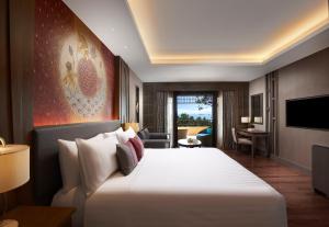 a hotel room with a large bed and a living room at Amari Vogue Krabi in Tab Kaek Beach
