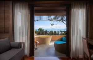 a living room with a view of a balcony at Amari Vogue Krabi in Tab Kaek Beach