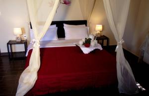 a bedroom with a large bed with a red blanket at Panorama Prespes in Agios Germanos
