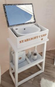 a white bathroom vanity with a sink and a mirror at STARLIGHT CAMP in Dubai