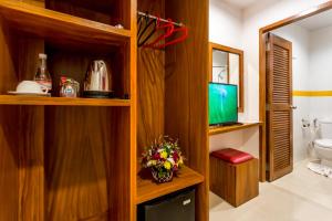 a bathroom with a toilet and a television in it at PJ Patong Resortel in Patong Beach