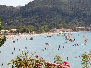 a group of people in the water at a beach at Romanza Studios in Vasiliki
