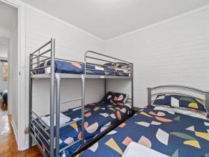 a bedroom with two bunk beds in a room at Pronto Apartments in Perth