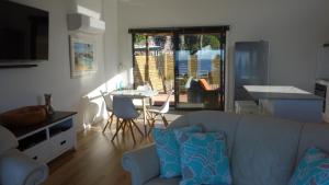 a living room with a couch and a table at THE LOFT @ Bay of Fires Seascape in Binalong Bay