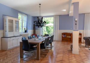 a kitchen and dining room with a table and chairs at Ferienhaus alte Kinderschule in Hausen am Tann +18 photos