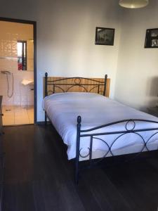 a bedroom with a bed and a bathroom with a shower at Chambres d hotes THE RESID in Pérouges