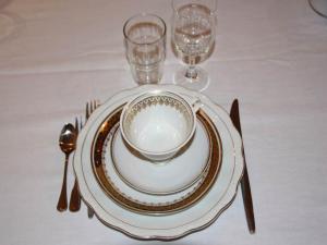 a table with a plate and a bowl and fork and knife at "Schwarzer Speicher" Stralsund in Stralsund