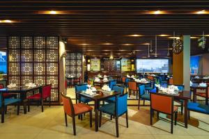 a dining room with tables and chairs in a restaurant at Saigon Hotel in Ho Chi Minh City