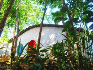 a white building in the middle of a forest at Phu Nam House - Resort in Phú Quốc