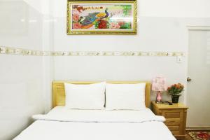 a bedroom with a bed and a picture on the wall at Saigon City Center Hostel in Ho Chi Minh City +23 photos