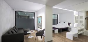a living room with a couch and a bedroom at YOTEL Istanbul Airport, City Entrance in Istanbul +37 photos
