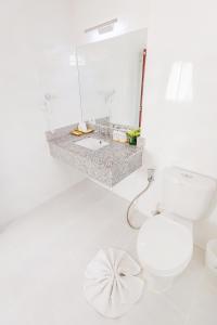 uma casa de banho branca com um WC e um lavatório em Roseate Chiang Mai em Chiang Mai