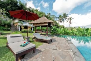 a resort with a pool and a gazebo at Villa Kembang Bali Ubud in Ubud
