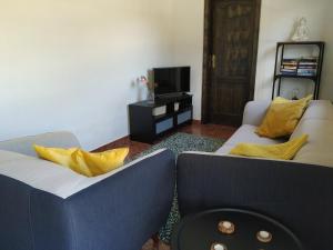 a living room with two couches and a tv at Casa Vista Bella in El Cercado