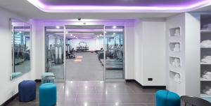 a room with a gym with blue chairs at YOTEL Istanbul Airport, City Entrance in Istanbul