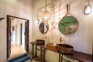 a bathroom with two sinks and a mirror at Tina house/Hoi An Central in Hoi An