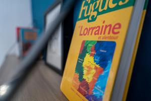 a book sitting on top of a shelf at Studio Craffe Nancy - Calme Cosy Lumineux et Parking in Nancy