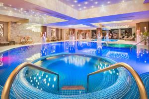 a pool in a hotel with blue water at Park & Spa Hotel Markovo in Plovdiv