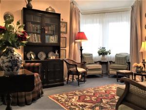 a living room with a large book shelf and a table at Carnaby Lodge in Dingwall